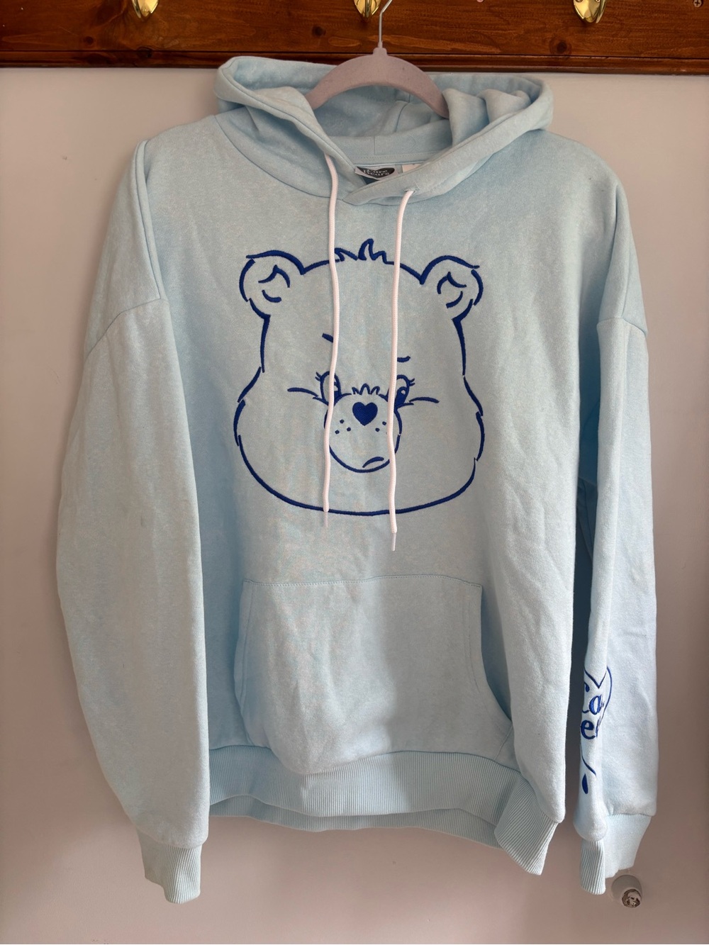 Care Bears Light Blue Crewneck Hoodie with Navy Bear Graphic